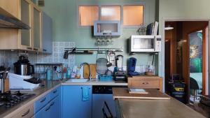 a kitchen with blue cabinets and a counter top at FLORAC AUTHENTIQUE in Florac