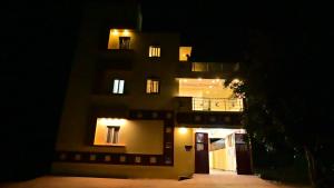 a building at night with its lights on at Mercury JKR Residency in Yelagiri