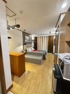 a large room with a bed and a desk in it at A Comfy Place in Tagaytay in Sampong