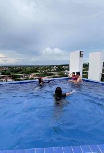 a group of people swimming in a swimming pool at A Comfy Place in Tagaytay in Sampong
