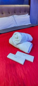 a pair of towels on top of a bed at A Comfy Place in Tagaytay in Sampong