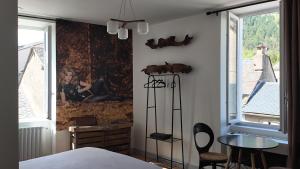 a bedroom with a painting on the wall at FLORAC AUTHENTIQUE in Florac