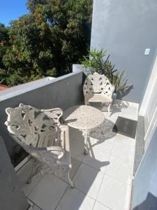 two chairs and a table on a patio at Espaço Familiar com Piscina in São Luís