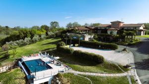 an aerial view of a house with a swimming pool at Garda Hill Boutique Apartments with Panoramic Pools e Agriturismo in Soiano del Lago
