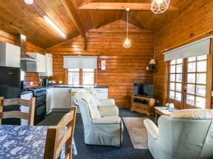 a kitchen with two chairs and a table at Lodge 2 - Bron Eifion in Criccieth
