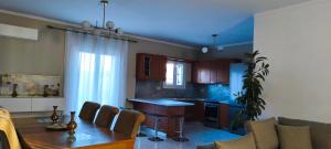a kitchen with a table and a dining room at Golden rose in Corfu +29 photos