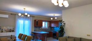 a kitchen and living room with a couch and a table at Golden rose in Corfu