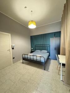 a bedroom with a bed and a table and a door at B&B International in Saviano