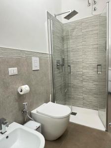 a bathroom with a shower and a toilet and a sink at B&B International in Saviano +4 photos