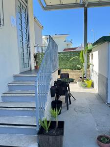 a patio with stairs and a table and chairs at B&B International in Saviano