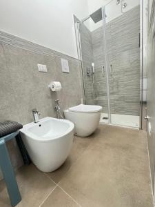 a bathroom with a tub and a sink and a shower at B&B International in Saviano