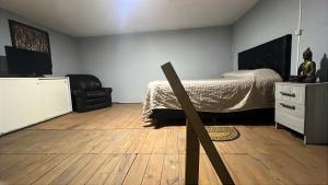a bedroom with a bed and a chair in it at La Esperanza in Deán Funes +3 photos