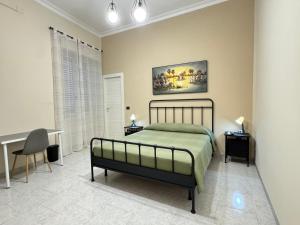 a bedroom with a bed and a desk in it at B&B International in Saviano