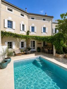 a swimming pool in front of a house at Cotton House Pool & Garden in Novi Vinodolski