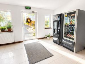 a room with a refrigerator with drinks in it at Confort INN in Otopeni