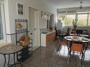 a kitchen and living room with a table and chairs at Casa del Sol in Gandía
