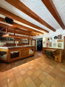 a large room with a bar and a table at Al Montel - Tre faggi in Borgo +45 photos