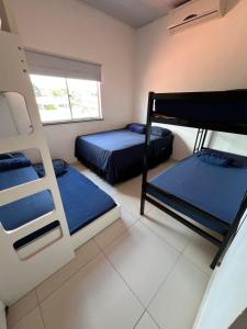a room with two bunk beds and a window at Espaço Familiar com Piscina in São Luís +30 photos
