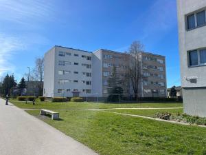 a building with a park in front of it at Comfort Haven Apartments in Jõhvi