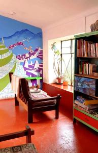 a living room with a painting on the wall at Aguaymanto pisac hostel in Pisac