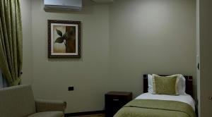 a hotel room with a bed and a chair at Rritja e Koranit in Pogradec