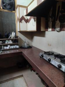 a kitchen with a stove and a counter top at Hexon Stays in Manāli +31 photos