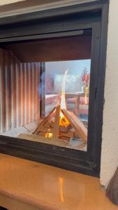a fire inside of a brick oven with a fire at Родопски Рай in Slaveino