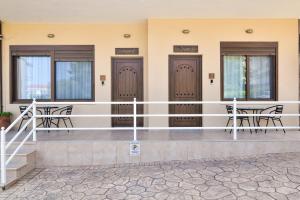 a row of doors in a building with chairs at Lito2Apart in Litochoro
