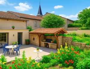 a patio with a gazebo in a garden at Gîte des 3 Suissesses in Saint-Paul