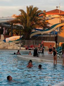 a group of people in the swimming pool at a resort at Escale Sud in Canet-en-Roussillon