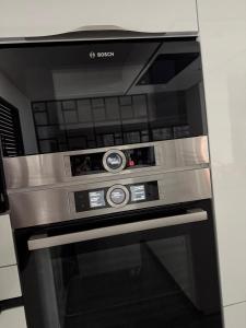 a black and silver oven in a kitchen at Villa avec piscine jacuzzi et sauna in Saint-André-de-Cubzac
