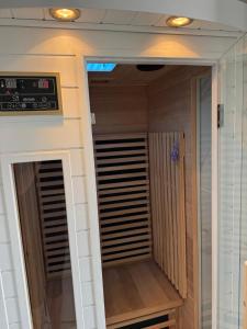a walk in closet in a room with wooden floors at Villa avec piscine jacuzzi et sauna in Saint-André-de-Cubzac