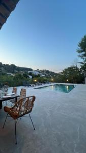 a pool with chairs and a table next to it at Bas de villa indépendant prestations haut de gamme in Vallauris