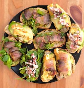 a black plate of sandwiches with lettuce and meat at Guesthouse Acherusia in Bacoli