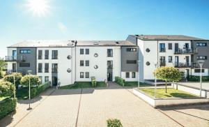 an apartment building with the sun in the background at Stunning 2 bed Mamer free parking in Mamer