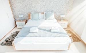 a bedroom with a large white bed with blue pillows at Stunning 2 bed Mamer free parking in Mamer