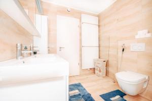 a bathroom with a white toilet and a sink at Stunning 2 bed Mamer free parking in Mamer +33 photos