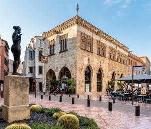a statue of a woman in front of a building at Passage Foch centre historique in Perpignan