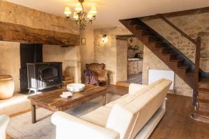 a living room with a couch and a fireplace at Camping and Gîtes - Le Mas d'Ayen in Ayen