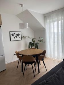 a dining room table and chairs in a room at Dobre Miejsce in Skoczów
