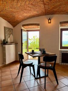 a dining room with a table and two chairs at B&B Casa Oleandro in Chiaverano