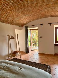 a bedroom with a bed and a door to a patio at B&B Casa Oleandro in Chiaverano