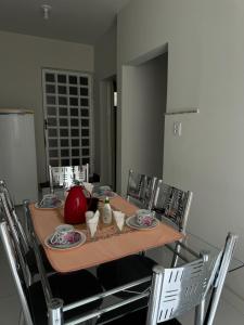 a table with plates and a tea pot on it at Apartamento do Sol in Diamantina