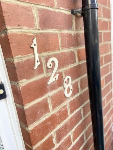 a brick wall with two numbers on it at Stay at 128 in Walker Gate +64 photos
