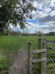 a wooden fence in front of a field at Stay at 128 in Walker Gate