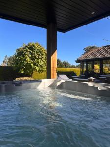 a plunge pool in a backyard with a gazebo at Fairways Villa Newcastle in Newcastle
