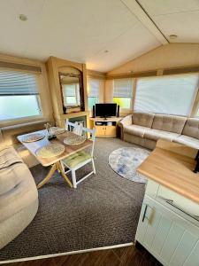 a living room with a table and a couch at The Conwy Escape in Conwy