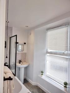 a bathroom with a tub and a sink and a window at Luxury Holiday Apartments in Torquay +70 photos