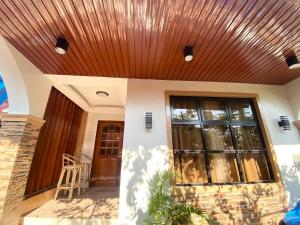 a house with a wooden ceiling at Arceo Homestay 2 Bedroom unit in Puerto Princesa City