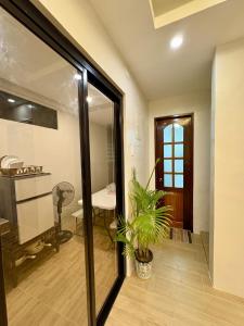 a room with a sliding glass door with a plant at Arceo Homestay 2 Bedroom unit in Puerto Princesa City +32 photos